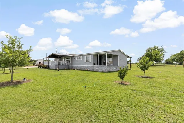 a swimming pool with outdoor seating and yard