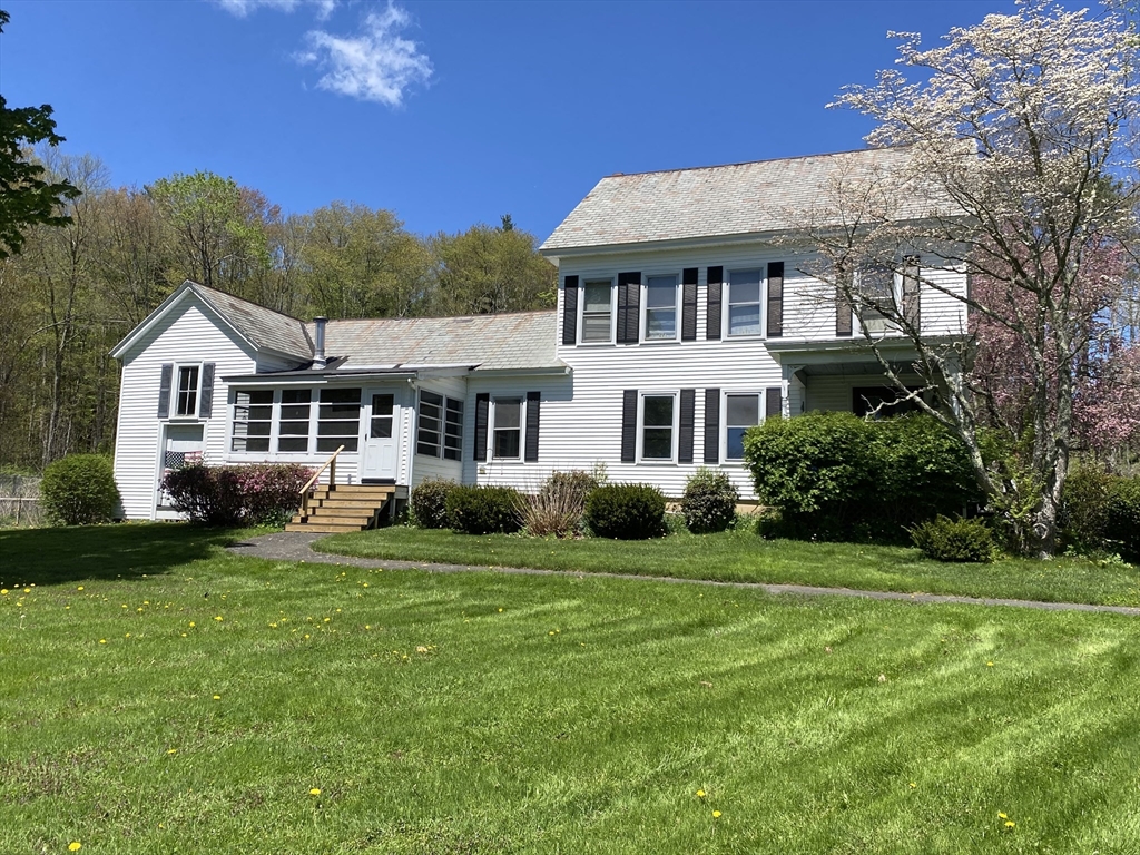 109 Brookfield Road Brimfield, MA 01010 - Photo 1 of 19 a front view of a house with a garden