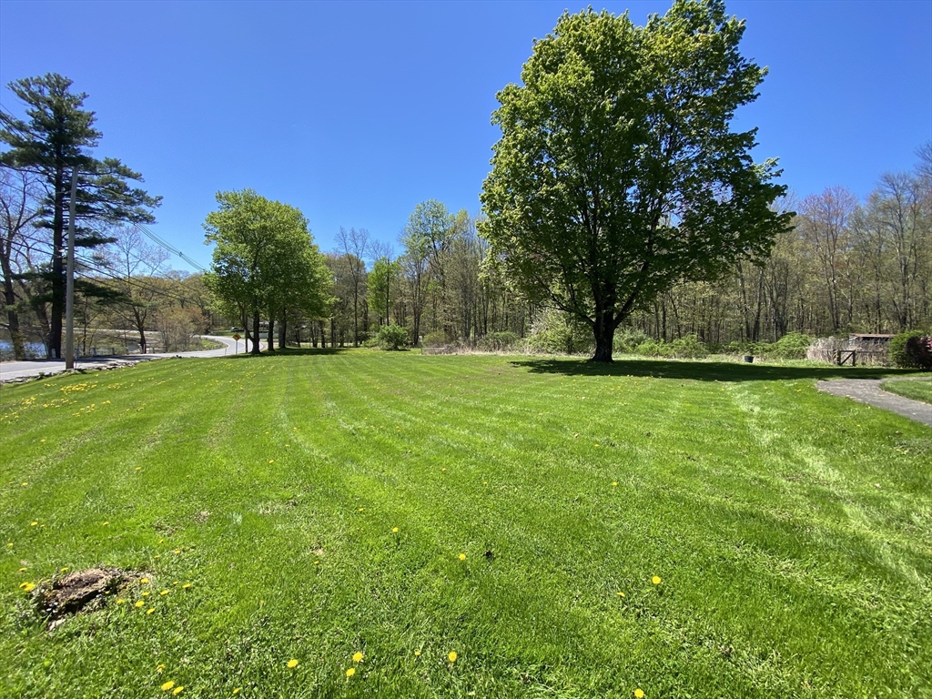 109 Brookfield Road Brimfield, MA 01010 - Photo 2 of 19 a view of grassy field with benches and trees all around
