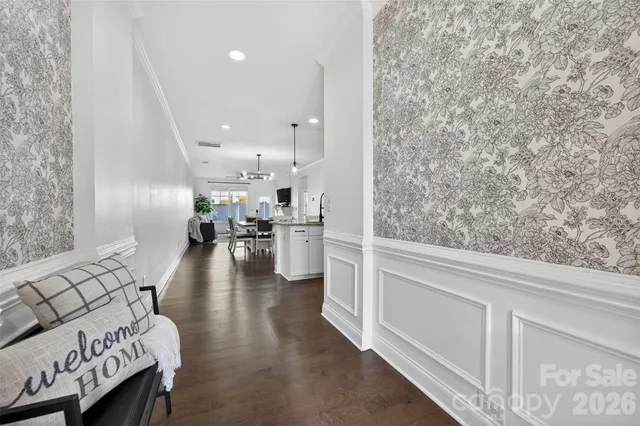 a view of a room with wooden floor and a ceiling fan