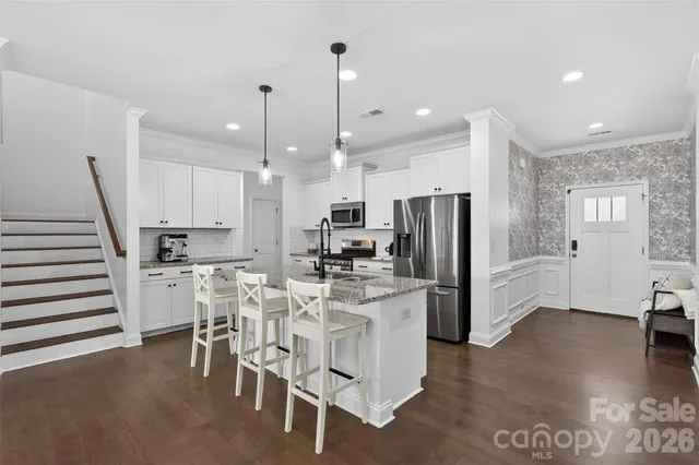 a bedroom with a bed and a potted plant