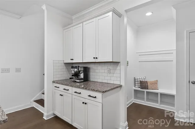 a bedroom with a bed and painting on the wall