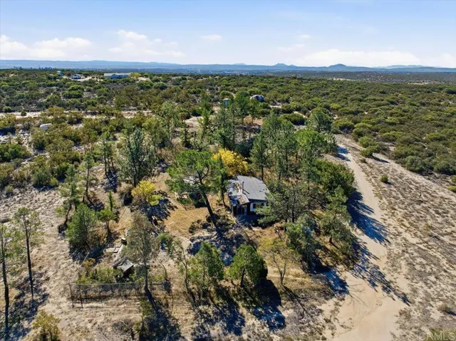 a view of a wooden house with a yard