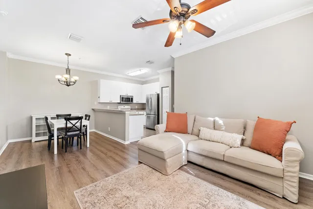a living room with furniture kitchen view and a dining table