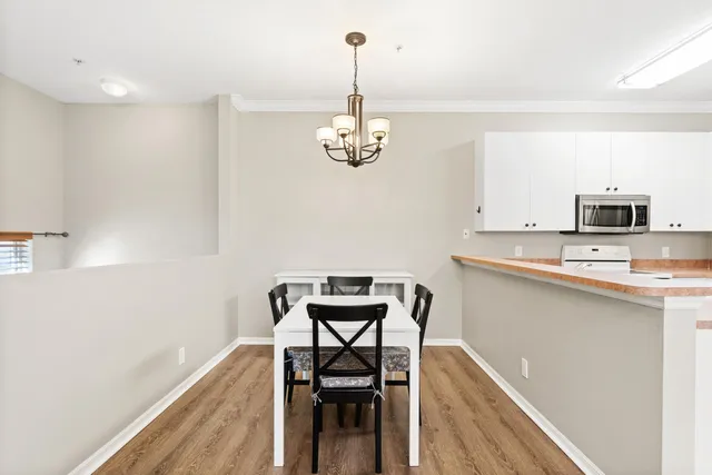 a view of a dining room with furniture wooden floor and a chandelier