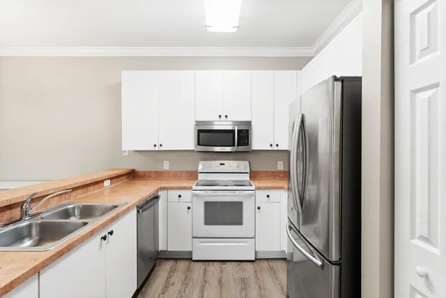 a kitchen with a sink stove and microwave