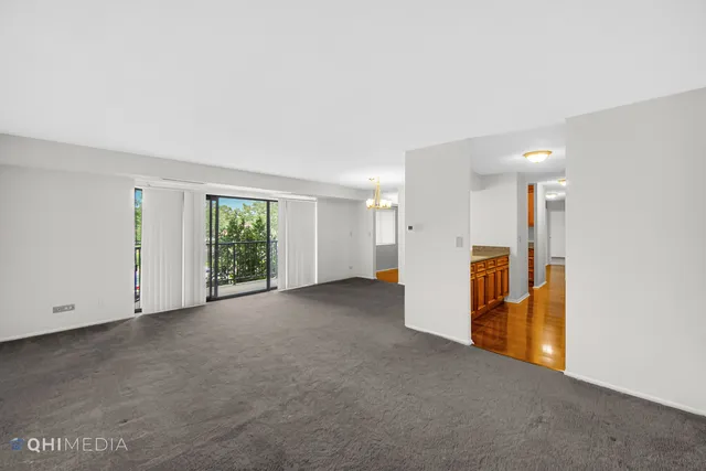 a view of a room with a refrigerator and window