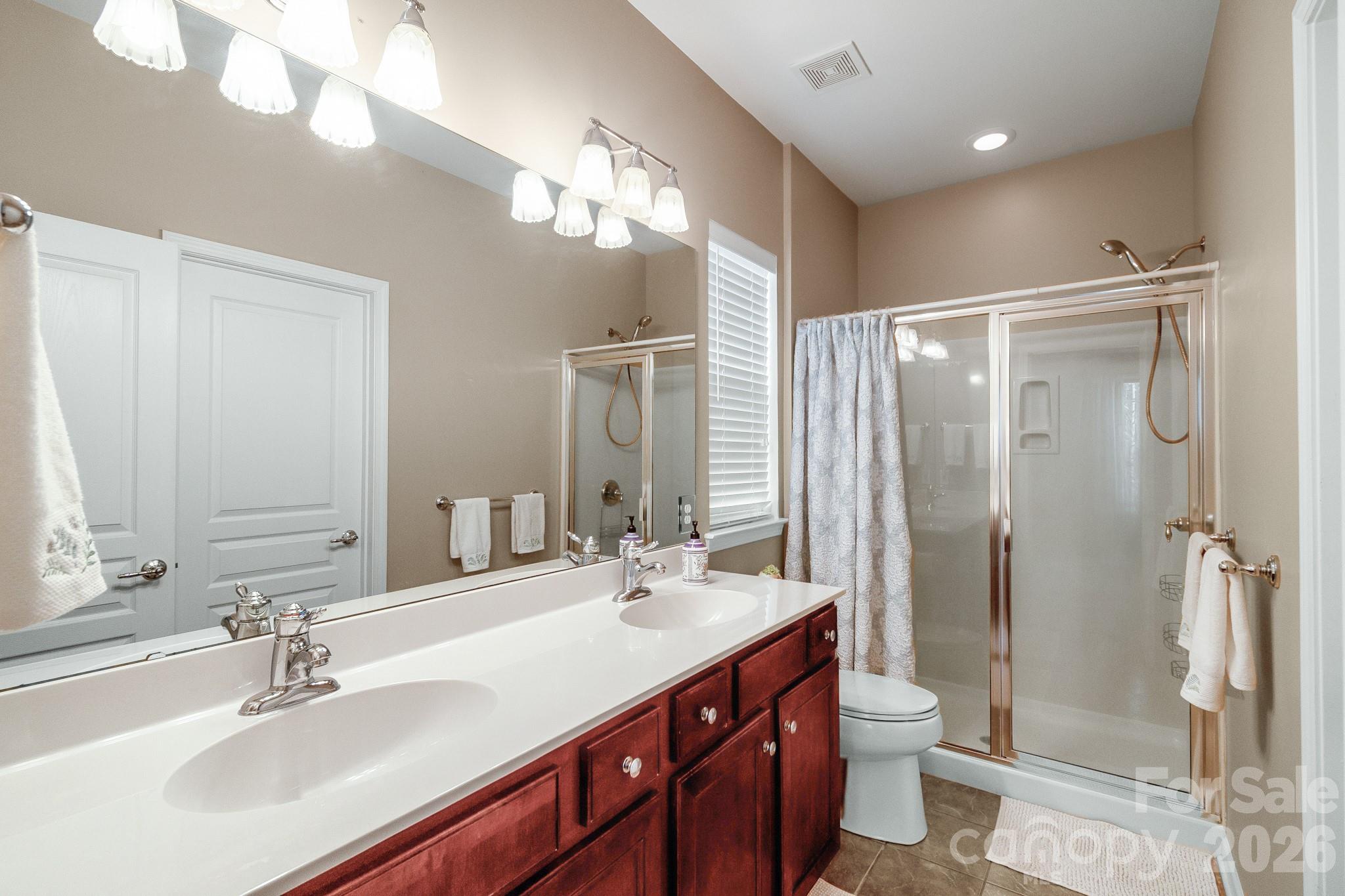 3037 Azalea Drive Fort Mill, SC 29707 - Photo 15 of 24 a bathroom with a double vanity sink mirror and toilet