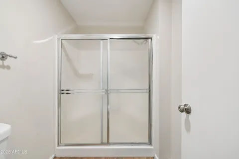 a bathroom with a glass shower door