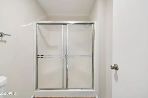 a bathroom with a glass shower door