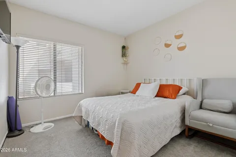 a bedroom with a bed and window