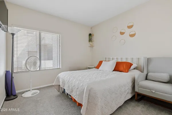 a bedroom with a bed and window