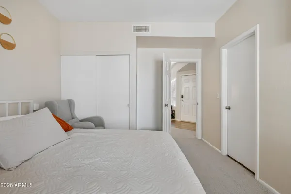 a bedroom with a bed and a closet