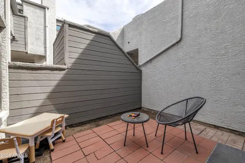 a backyard of a house with table and chairs
