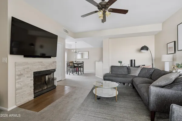 a living room with furniture a flat screen tv and a fireplace