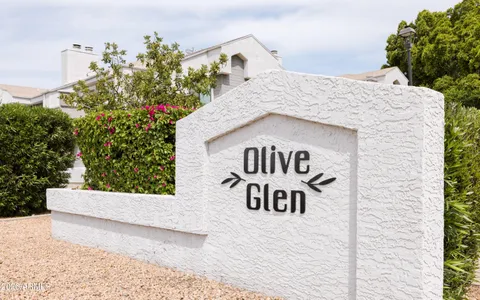 a view of a houses with a yard and palm trees