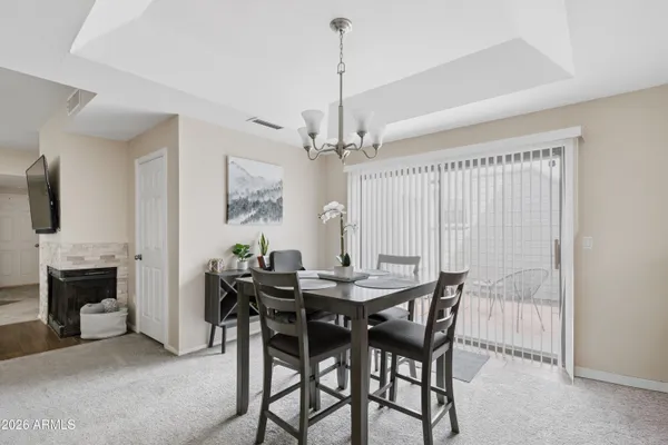 a view of a dining room with furniture and chandelier