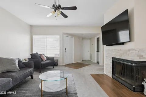 a living room with furniture a flat screen tv and a fireplace
