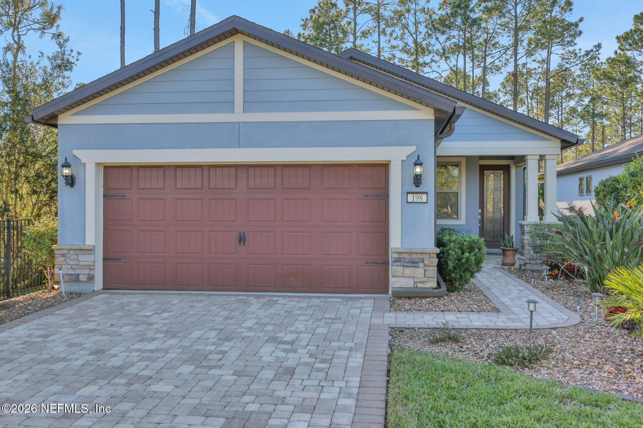 198 Forest Spring Drive Ponte Vedra, FL 32081 - Photo 5 of 56 a front view of a house with a yard and garage