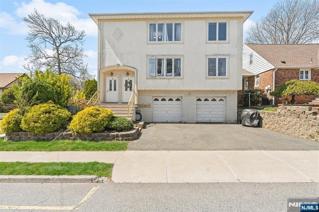19 Cherry Street Garfield, NJ 07026 - Photo 1 of 43 a front view of a house with garden