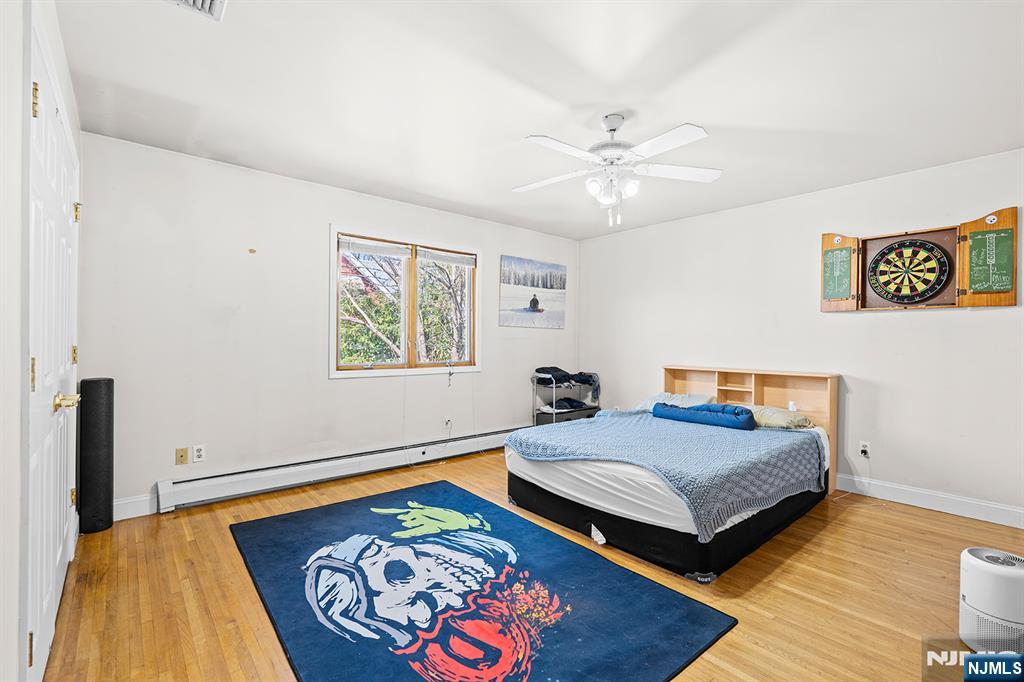 19 Cherry Street Garfield, NJ 07026 - Photo 12 of 43 a bedroom with a bed and a painting on the wall
