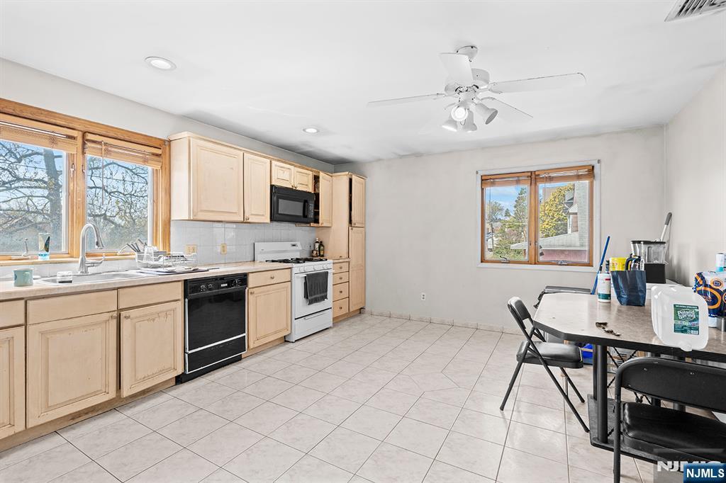 19 Cherry Street Garfield, NJ 07026 - Photo 14 of 43 a kitchen with a stove a sink and a microwave