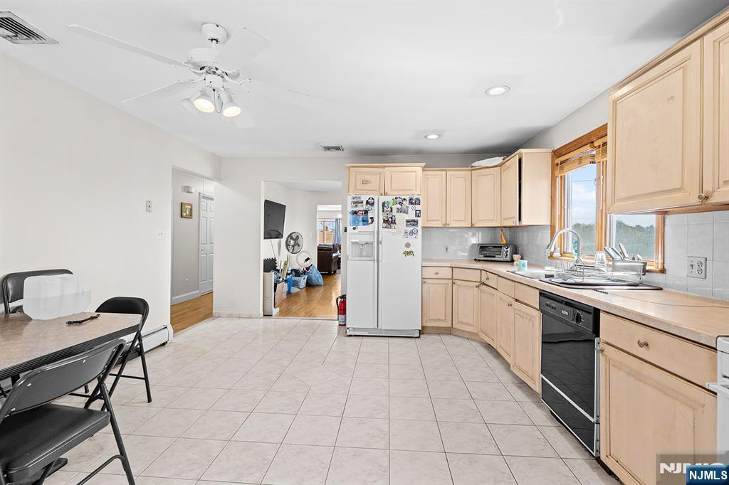19 Cherry Street Garfield, NJ 07026 - Photo 16 of 43 a kitchen with a sink a counter top space cabinets and stainless steel appliances