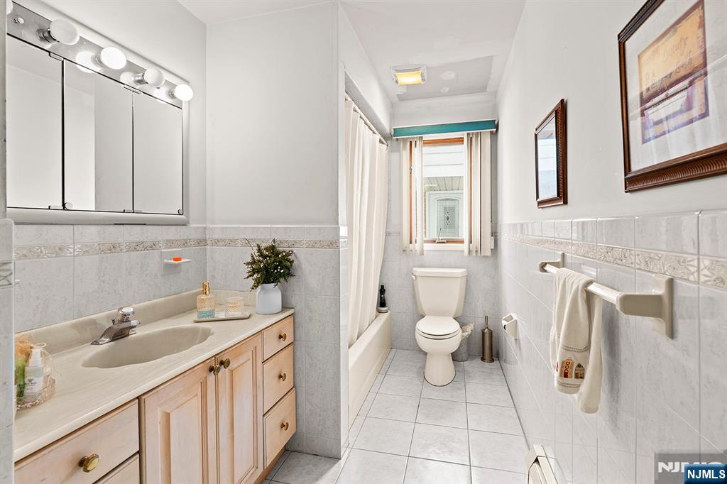 19 Cherry Street Garfield, NJ 07026 - Photo 25 of 43 a bathroom with a sink and a toilet