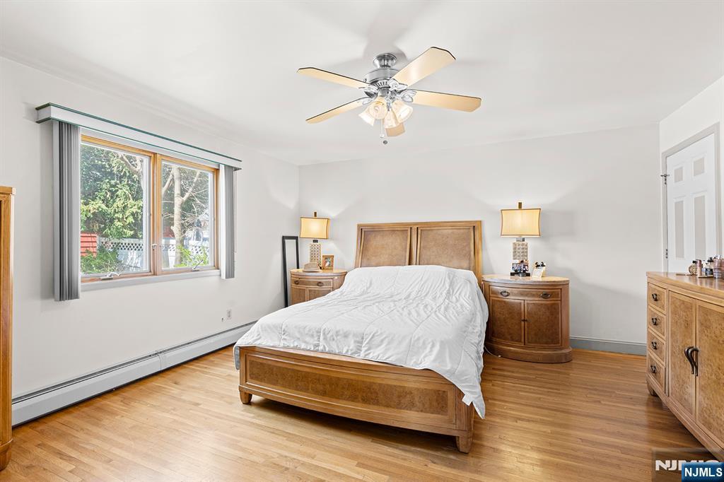 19 Cherry Street Garfield, NJ 07026 - Photo 26 of 43 a bedroom with a bed and a chandelier
