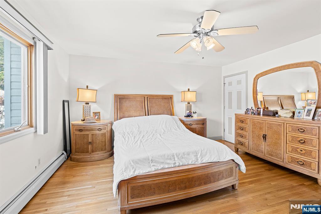 19 Cherry Street Garfield, NJ 07026 - Photo 27 of 43 a spacious bedroom with a bed and a dresser