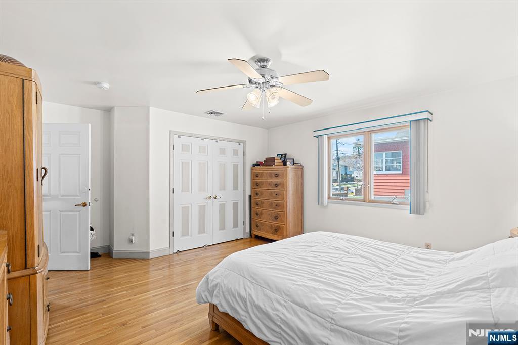 19 Cherry Street Garfield, NJ 07026 - Photo 28 of 43 a bedroom with a bed closet and a window