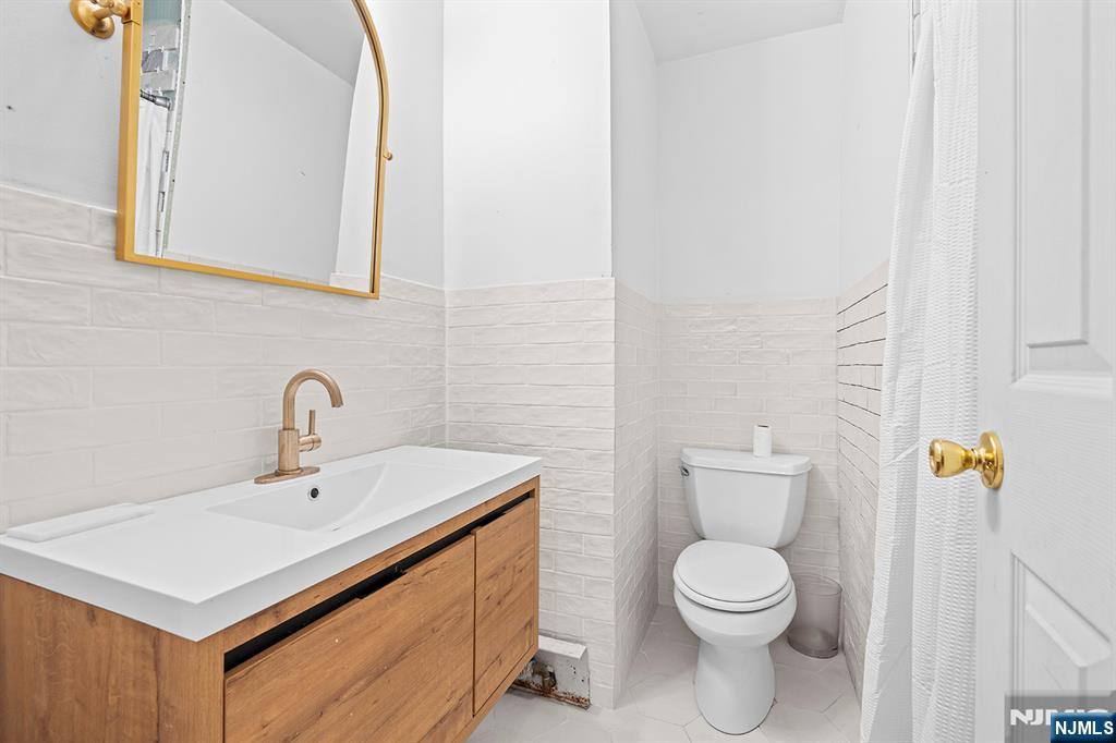 19 Cherry Street Garfield, NJ 07026 - Photo 33 of 43 a white toilet sitting next to a bathroom sink