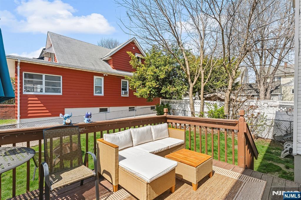 19 Cherry Street Garfield, NJ 07026 - Photo 35 of 43 a balcony with wooden floor and outdoor seating