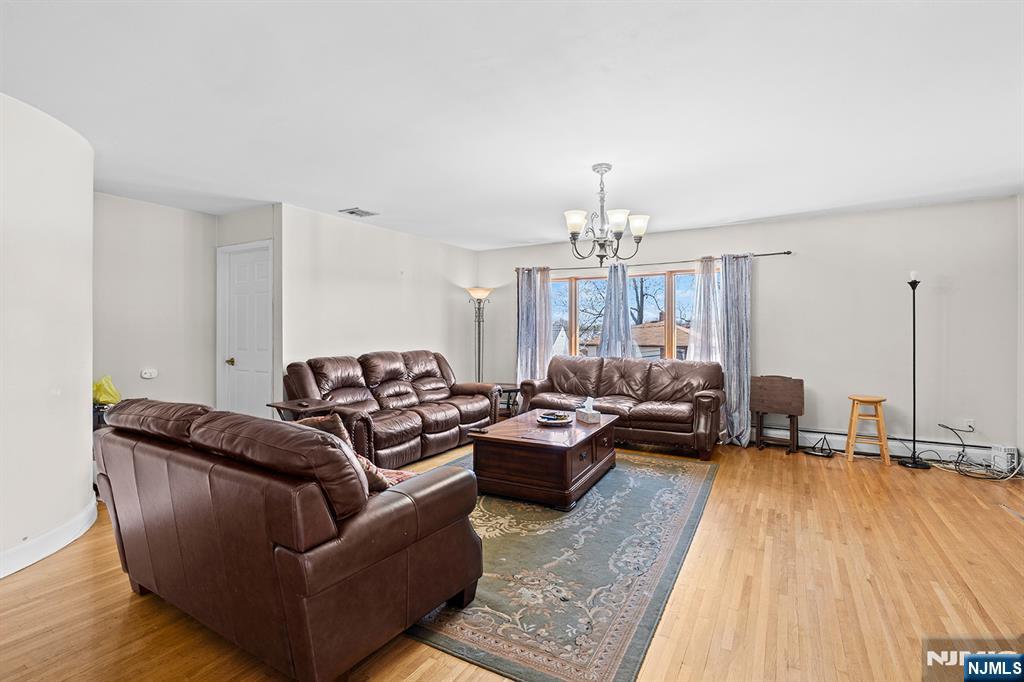 19 Cherry Street Garfield, NJ 07026 - Photo 5 of 43 a living room with furniture and a chandelier