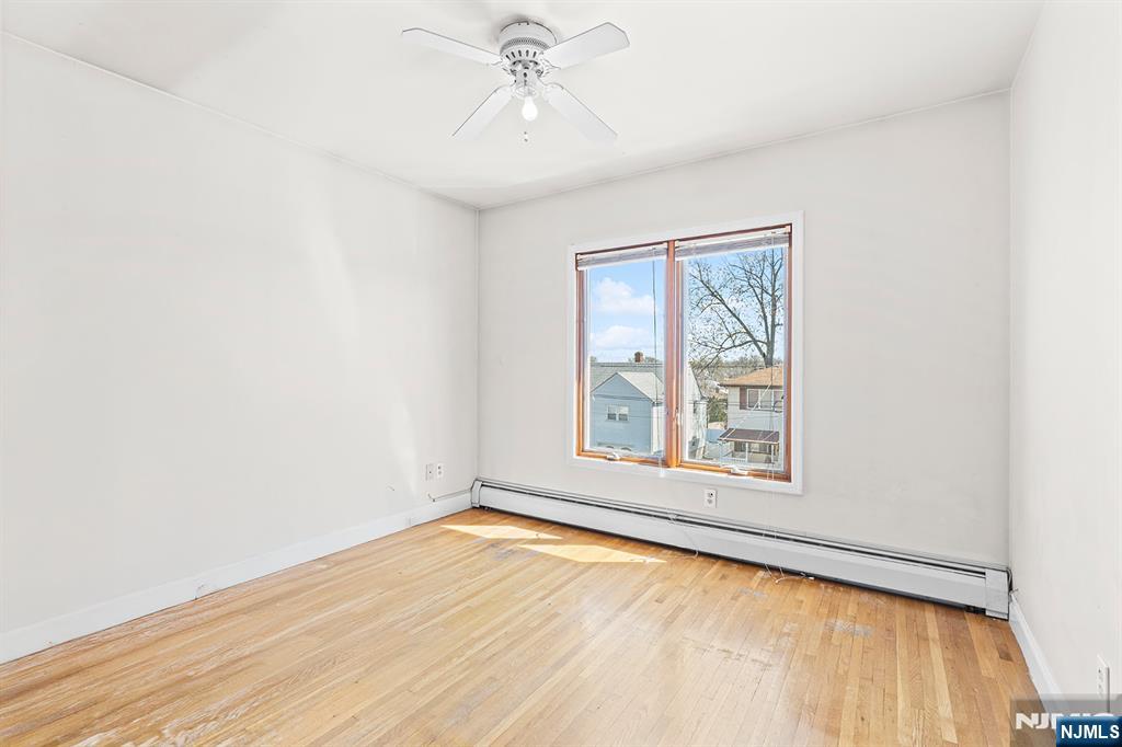 19 Cherry Street Garfield, NJ 07026 - Photo 8 of 43 an empty room with a window and ceiling fan