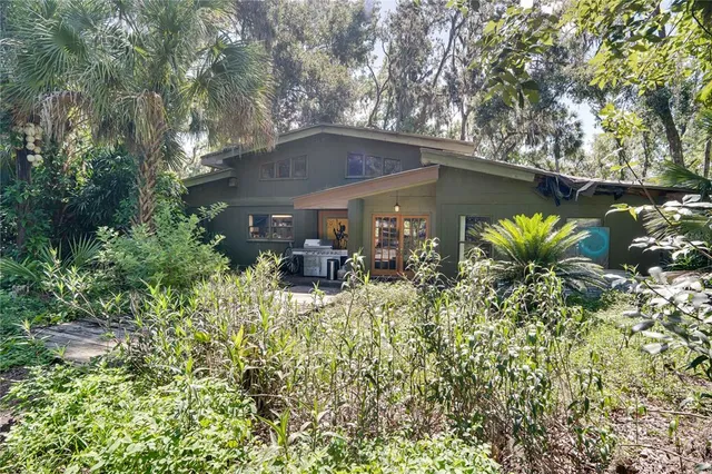 a view of a house with a yard and sitting area