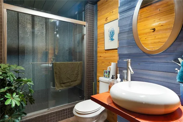 a bathroom with a sink a toilet and shower