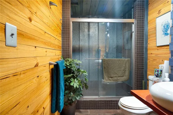 a bathroom with a toilet and a shower