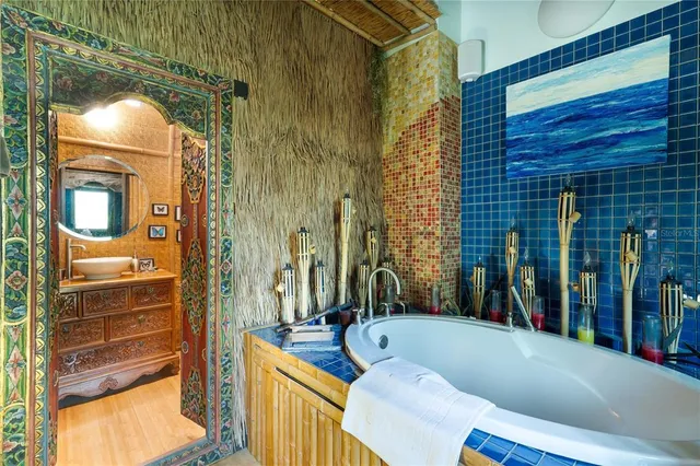 a view of bathroom with tub and door