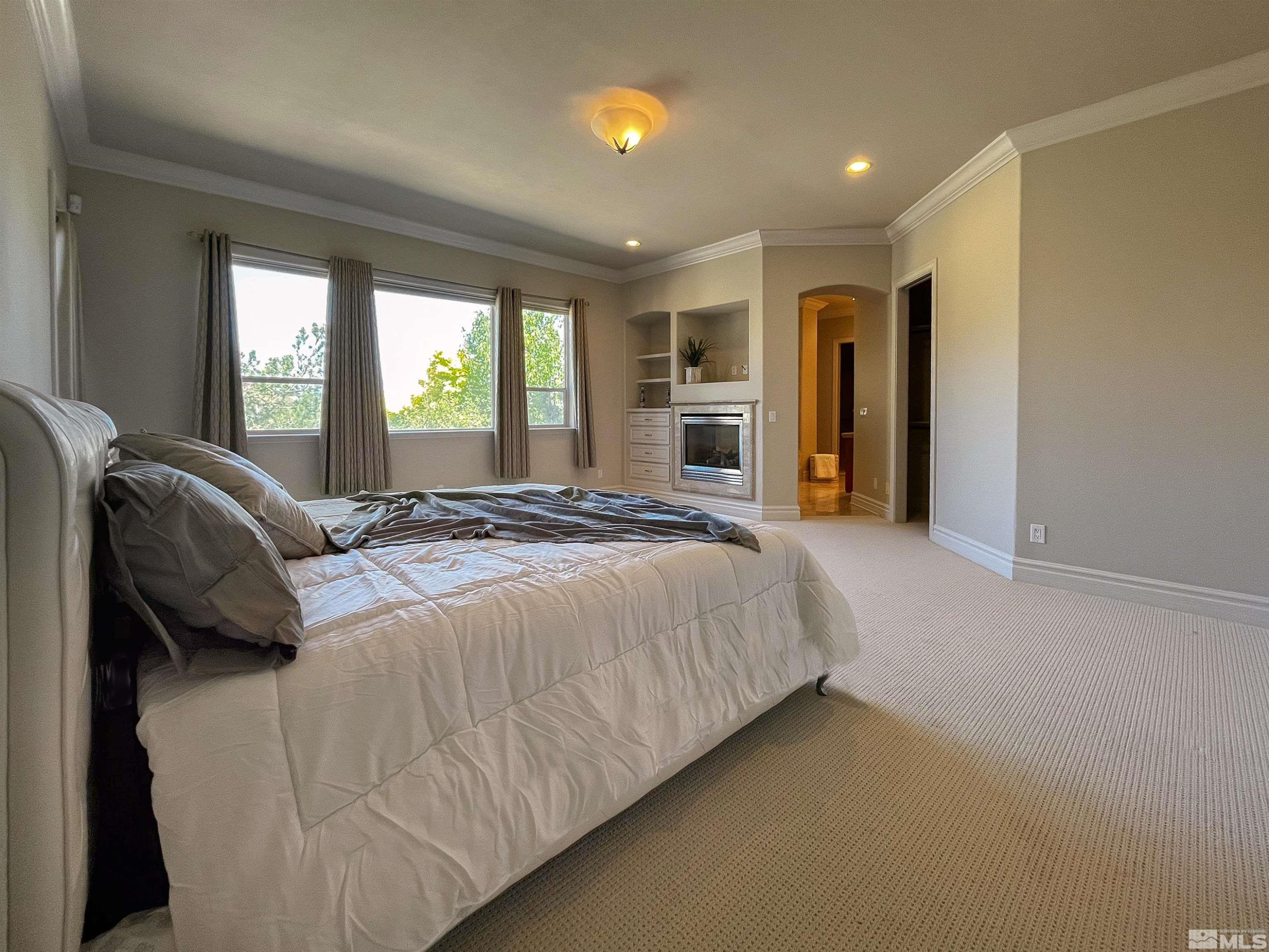 4875 Mountainshyre Road Reno, NV 89519 - Photo 11 of 13 a spacious bedroom with a bed and a couch