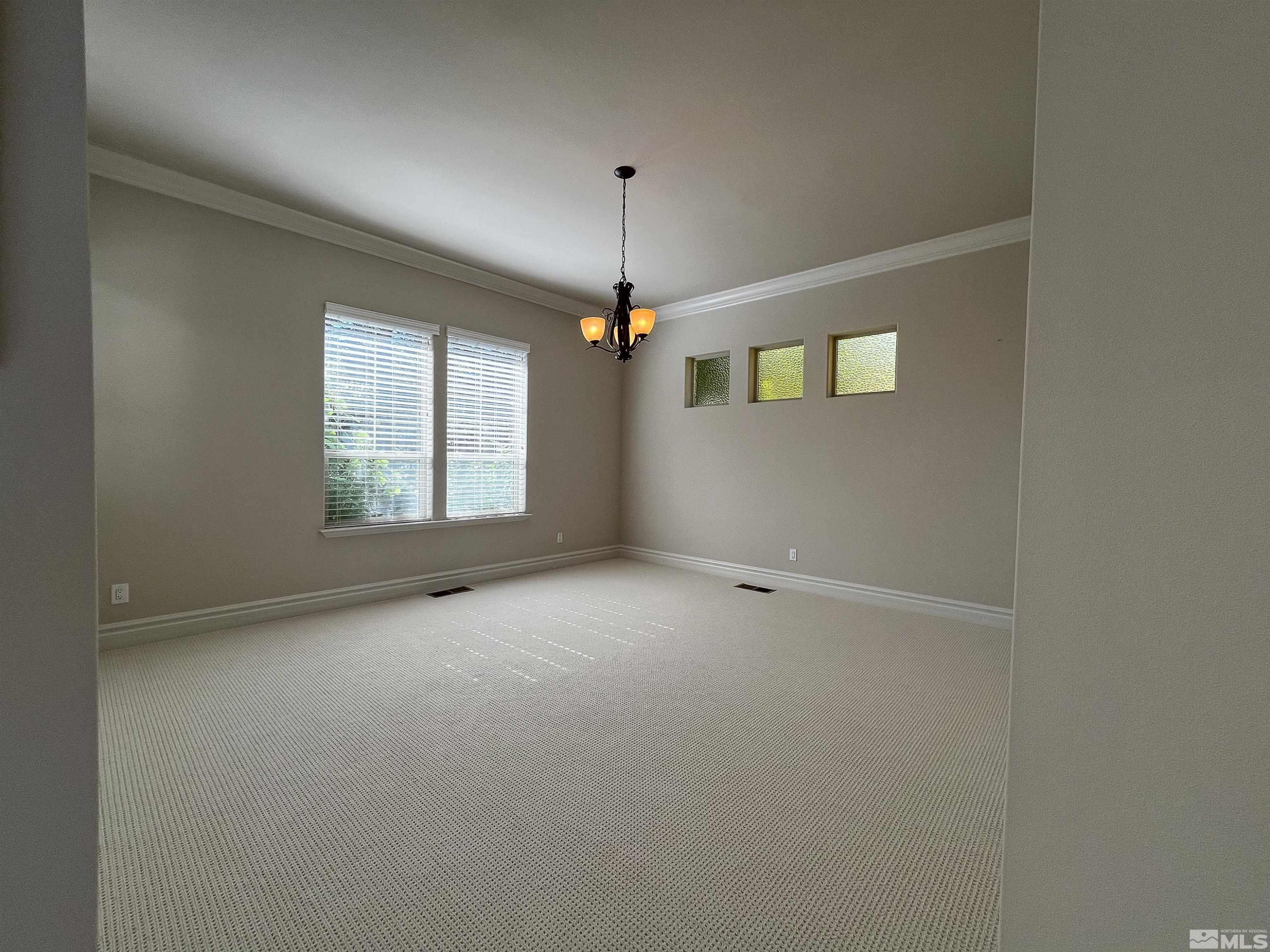 4875 Mountainshyre Road Reno, NV 89519 - Photo 6 of 13 an empty room with windows and fan