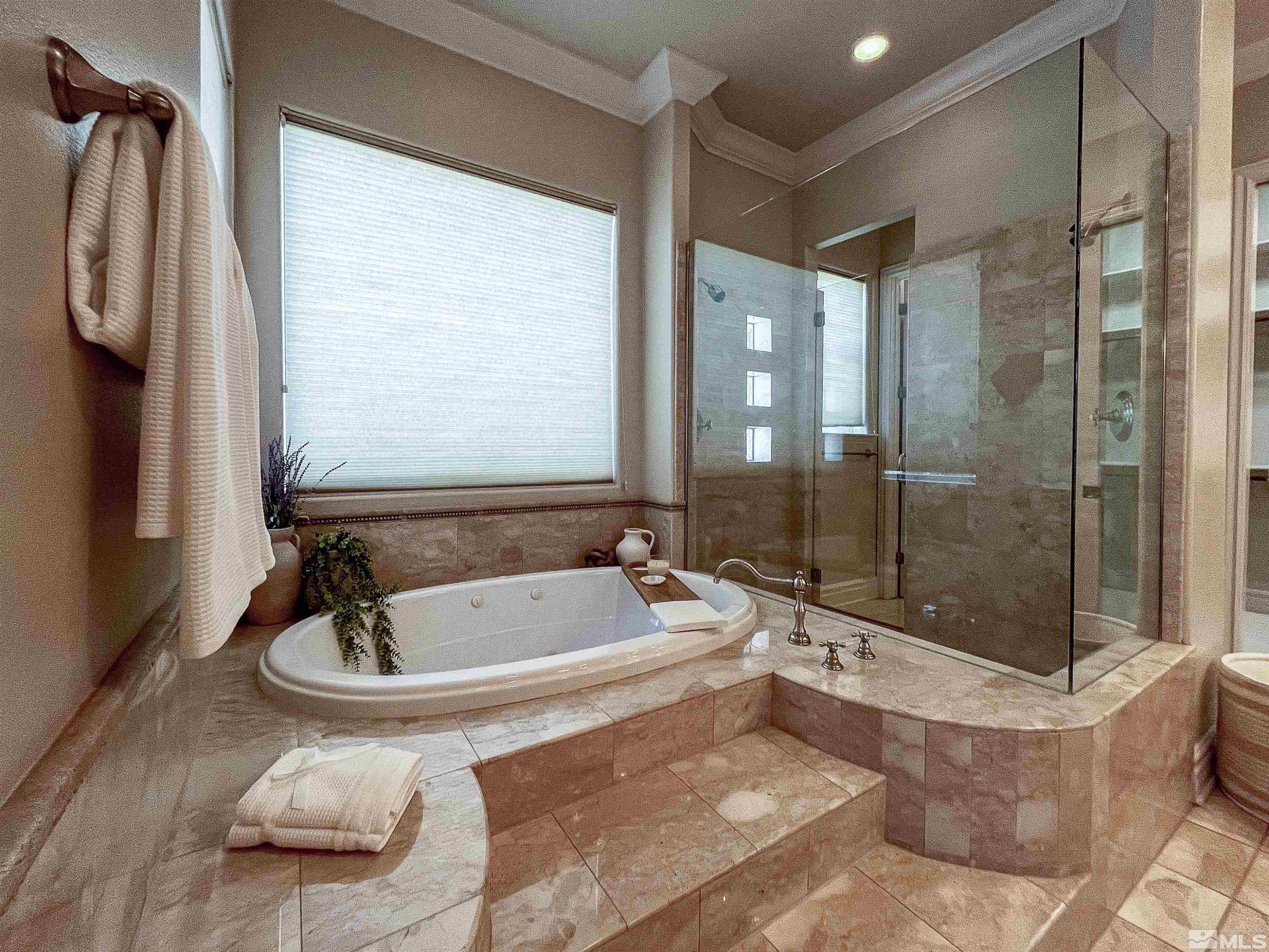 4875 Mountainshyre Road Reno, NV 89519 - Photo 10 of 13 a bathroom with a tub a sink and glass door