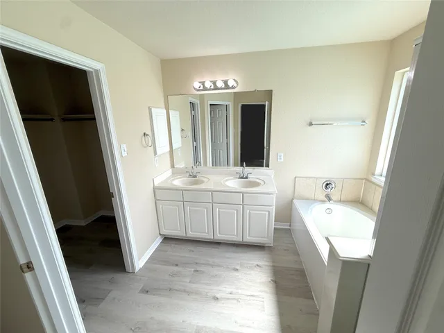 a bathroom with a sink a toilet a mirror and vanity