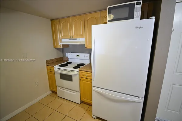 a view of a room with wooden floor and cabinet