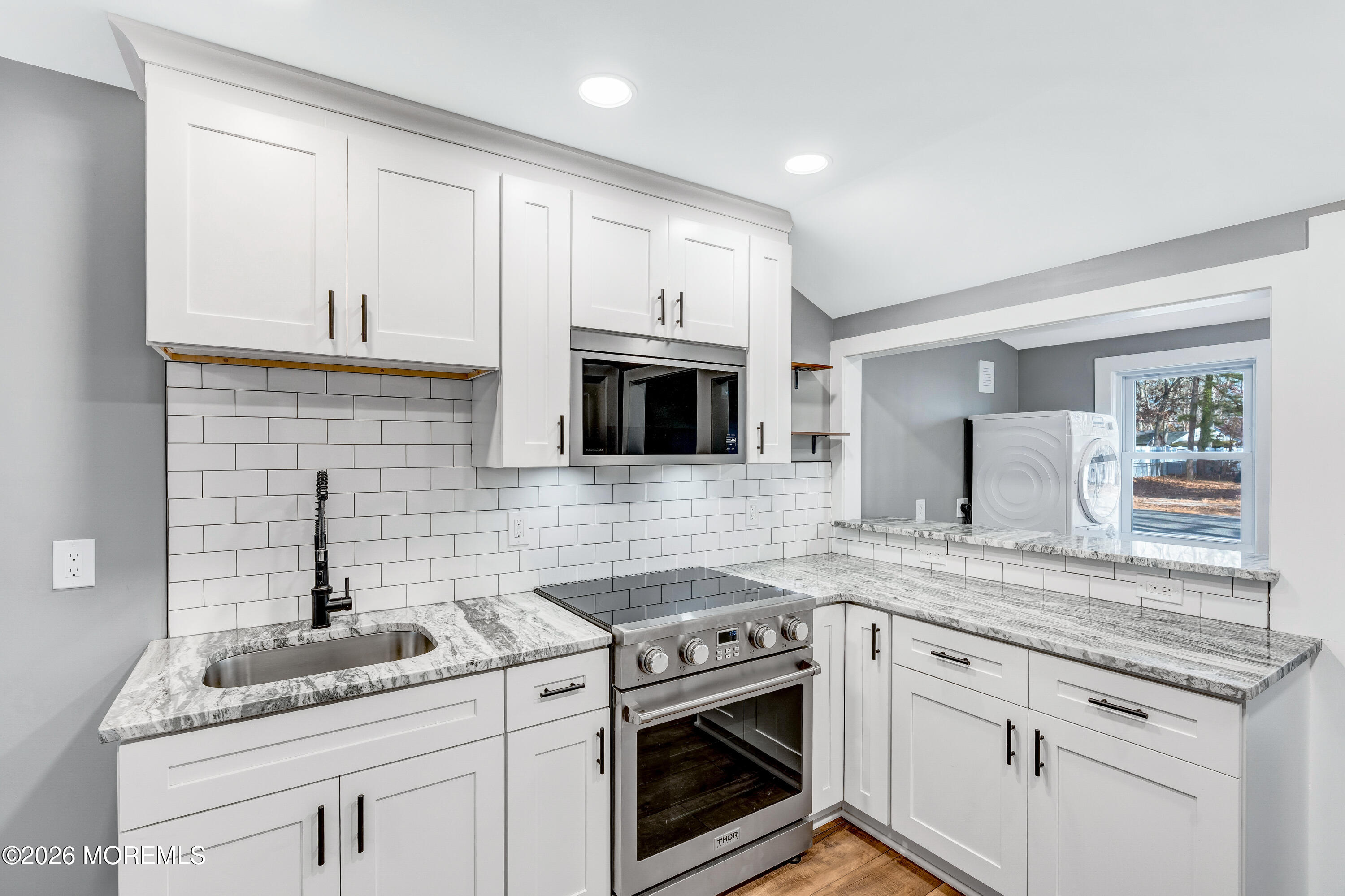 32 Chestnut Street Waretown, NJ 08758 - Photo 11 of 35 a kitchen with granite countertop white cabinets stainless steel appliances and a sink