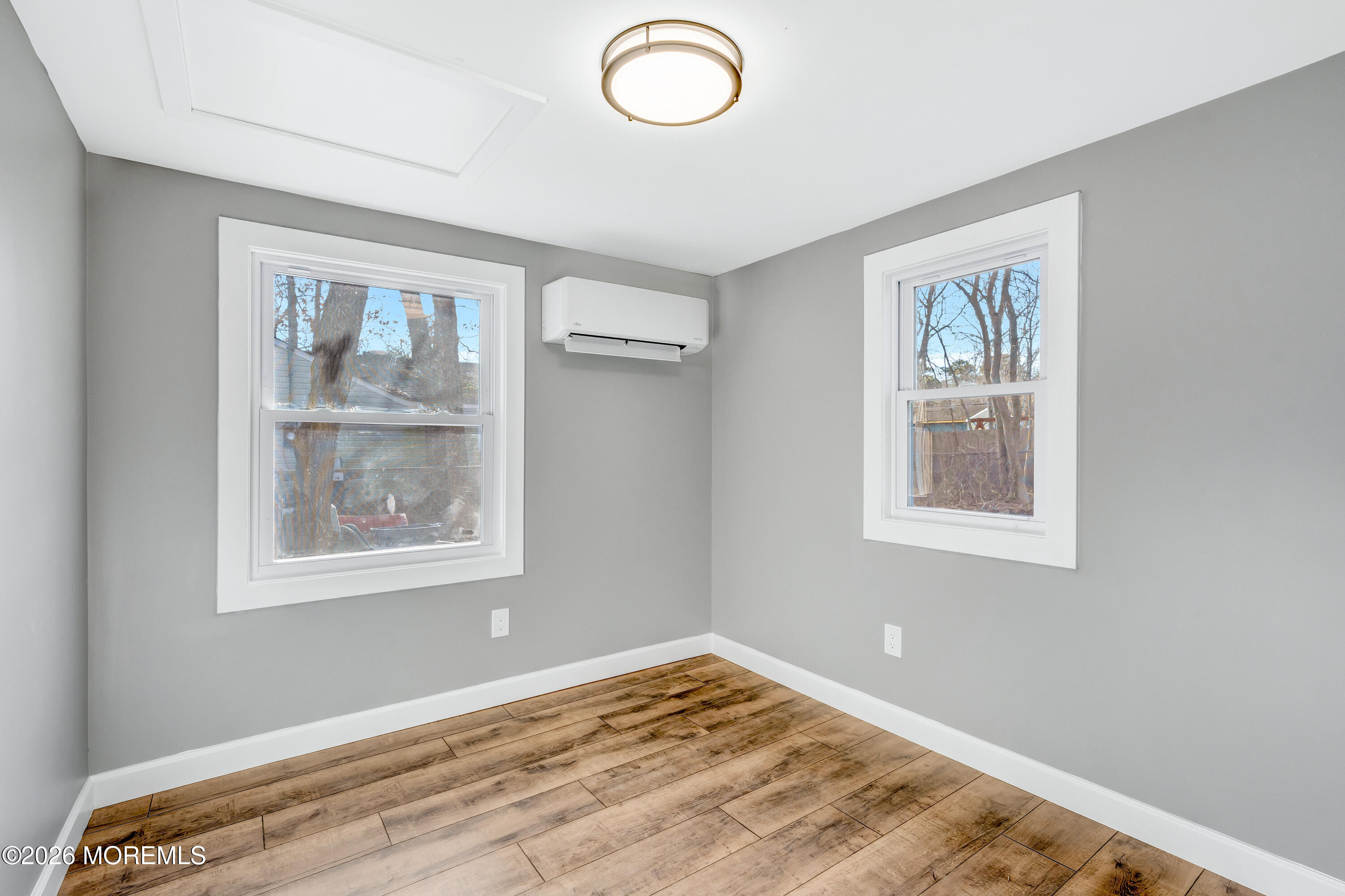 32 Chestnut Street Waretown, NJ 08758 - Photo 23 of 35 a view of a bedroom with window and wooden floor