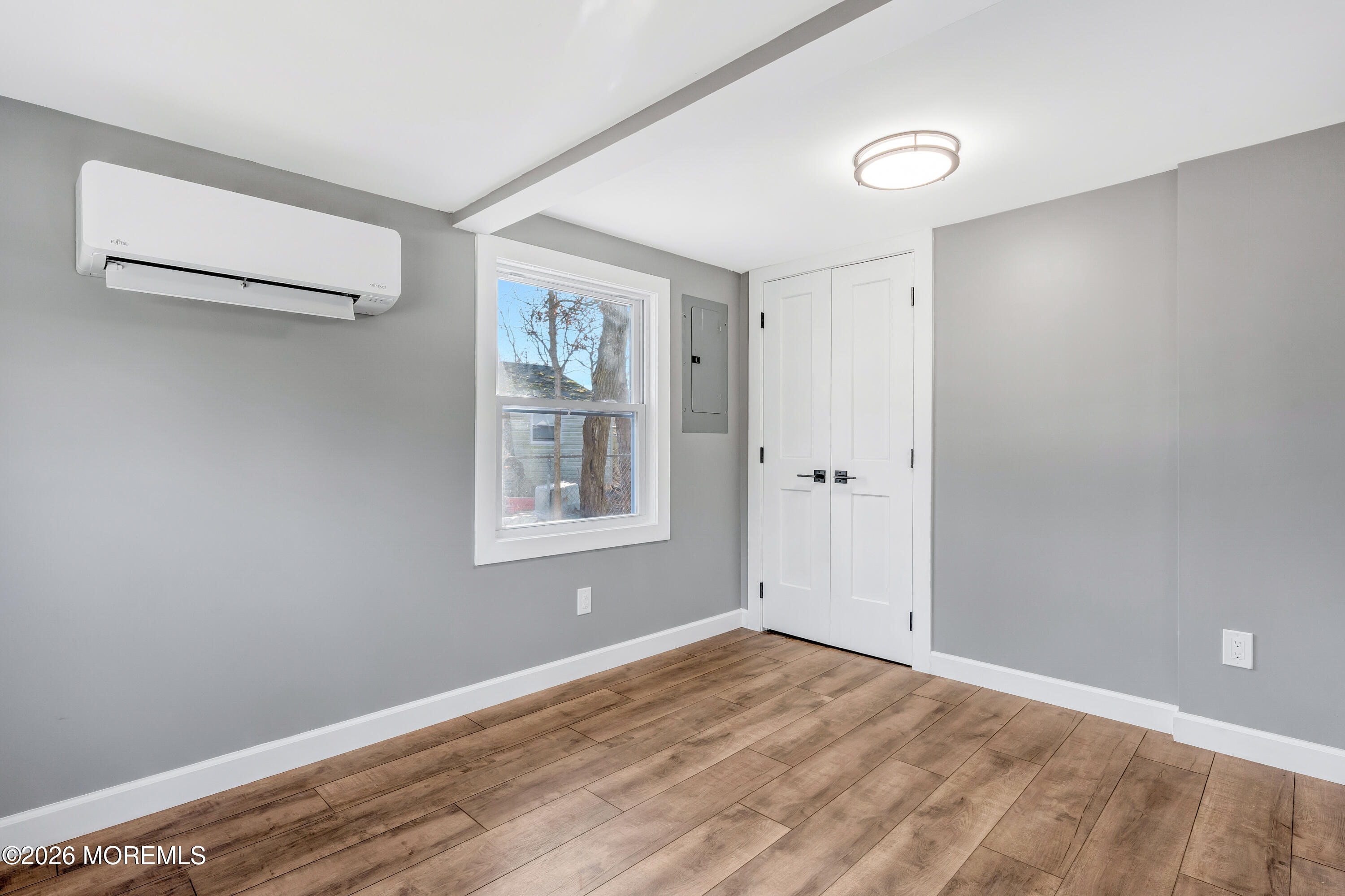 32 Chestnut Street Waretown, NJ 08758 - Photo 26 of 35 a view of a big room with wooden floor and windows
