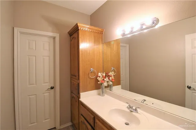 a bathroom with a sink vanity and a mirror
