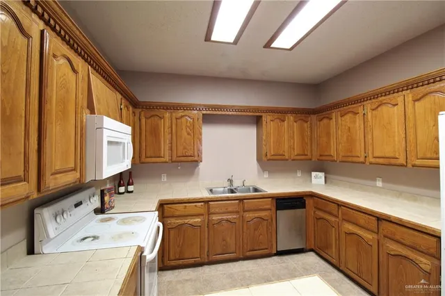 a kitchen with a sink a stove cabinets and a window