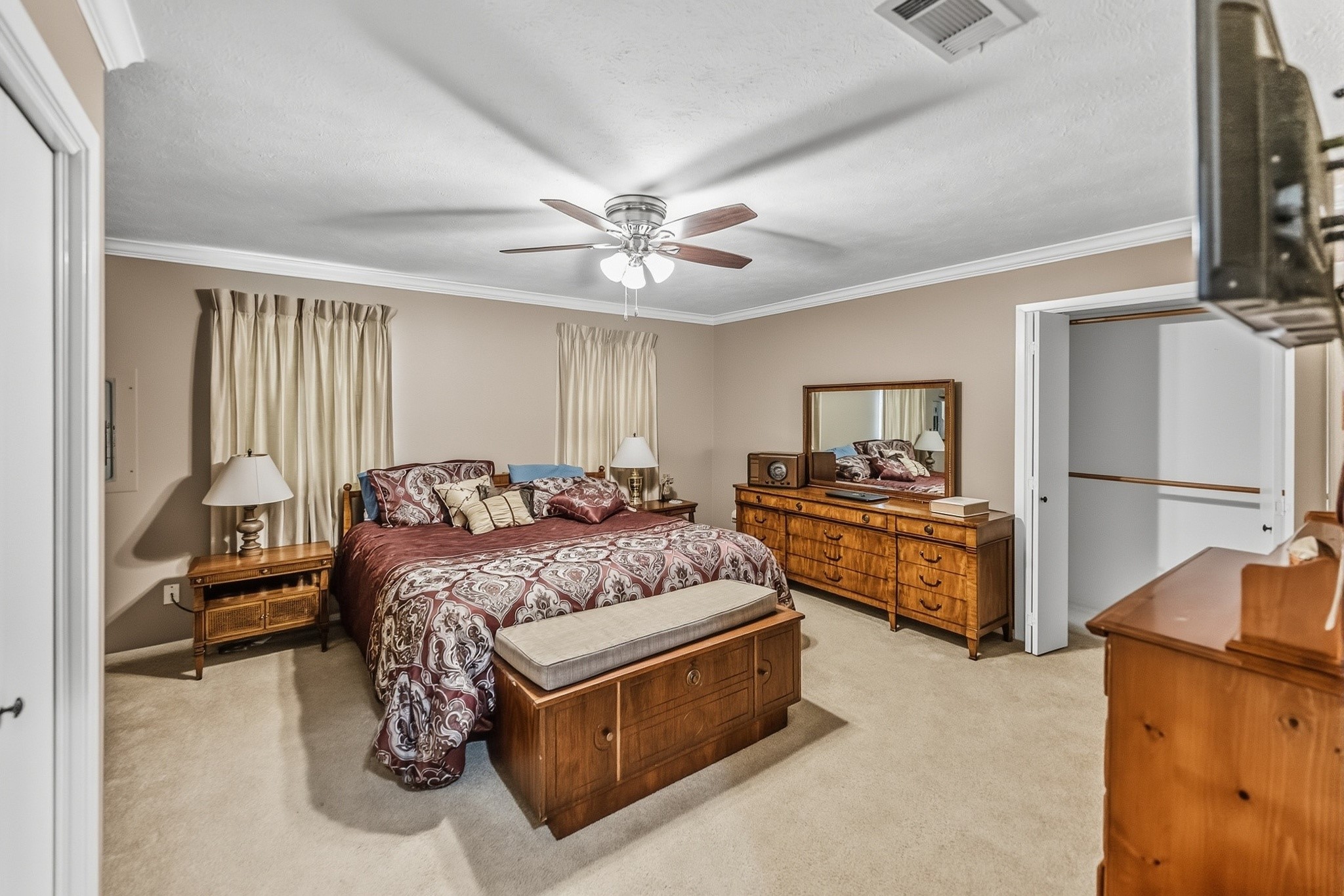 46 Point Loop Huntsville, TX 77320 - Photo 26 of 49 a spacious bedroom with a bed and a chandelier